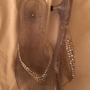 Clear, sparkly formal sandals with silver rhinestones on straps. Size 10.
